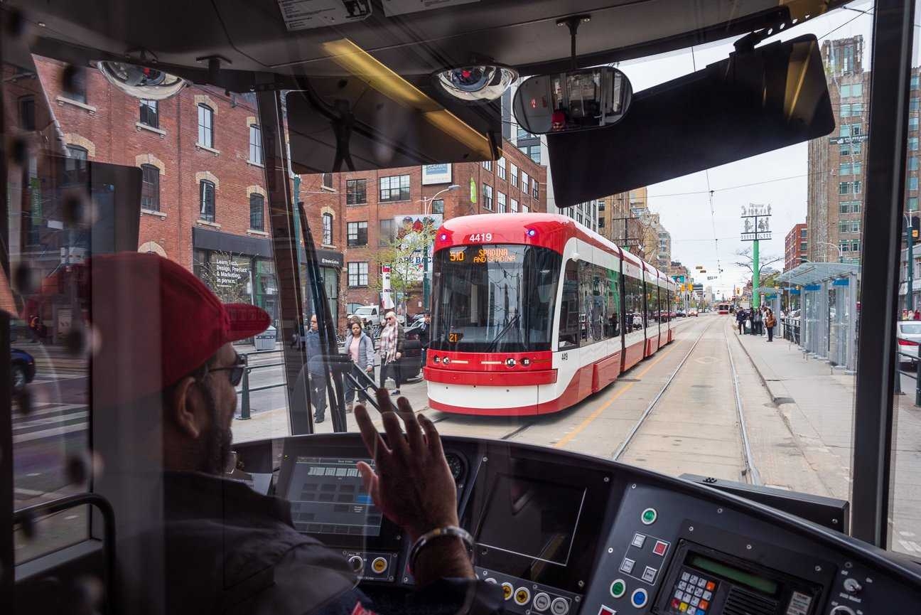 Friendly TTC streetcar drivers wave to each other in Toronto